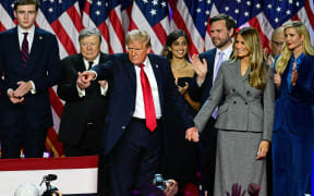Former US President and Republican presidential candidate Donald Trump gestures at supporters after speaking during an election night event at the West Palm Beach Convention Center in West Palm Beach, Florida, on November 6, 2024. - Republican former president Donald Trump closed in on a new term in the White House early November 6, 2024, just needing a handful of electoral votes to defeat Democratic Vice President Kamala Harris. (Photo by Jim WATSON / AFP)