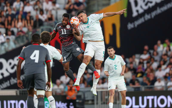 New Zealand's Michael Boxall New Caledonia's César Zeoula.