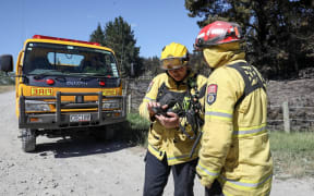 Firefighters working at the site of the West Melton fire on 9 December, 2024. (From left) Senior firefighter Emily Sutton and station officer Lou Ander.