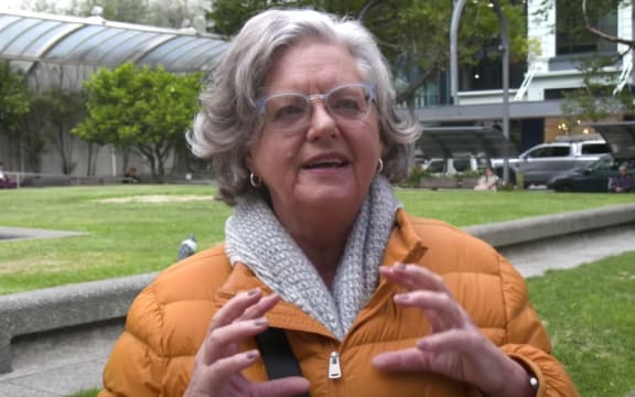 A person in an orange jacket tells RNZ about their favourite Easter foods