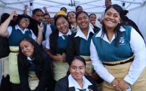 Southern Cross Campus Tongan students huddled under a small gazebo to shelter from the rain, still in high spirits despite the weather.