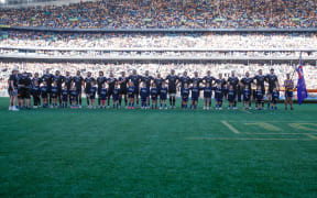 The All Blacks line up for the anthem.