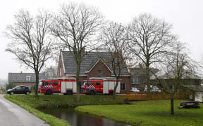 Vehicles are parked in front of the poultry farm in the village of Hekendorp, where a  strain of bird flu was found.