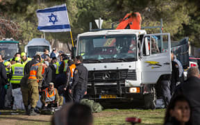 Officials examine the scene of the attack, which left four people dead.