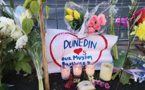 Flowers and candles were left outside Dunedin's Al Huda mosque this morning.