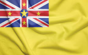 Niue flag on the fabric texture