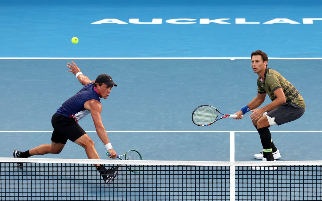 Artem Sitak (R) and Rubin Statham (L) of New Zealand in action in their doubles match against Romain Arnoldo of Monaco and Sam Weissborn of Austria.