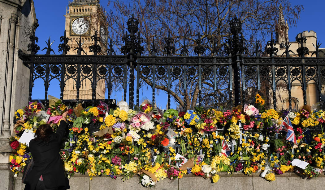 A well wisher lays flowers outside London's Houses of Parliament after the 22 March attack by Khalid Masood killed four and injured 29. Photo taken 25 March.