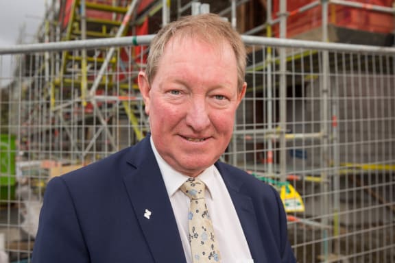 Nick Smith outside one of the Special Housing Areas in Auckland