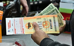 Lottery tickets for the Mega Millions lottery are purchased from a liquor store where winning tickets have been sold on December 27, 2024 in Hawthorne, California. - The ninth-largest lottery jackpot in US history worth $1.15 billion will be drawn tonight in the Mega Millions drawing, after no tickets with all six numbers have been sold in 30 consecutive drawings. (Photo by Frederic J. BROWN / AFP)