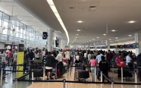 Crowds at Auckland Airport as travelers head away for Christmas 2024.