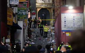 Emergency service personnel are seen in the alley where a Halloween stampede took place late 29 October, in the neighbourhood of Itaewon in Seoul on October 30, 2022.