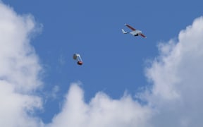 A Zipline drone dropping off medical supplies