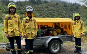 Sounds Rural Volunteer Fire Brigade members Tyst Hertoghs, fire chief Trevor Hook and Mika Boniface with one of the trailers used for fighting fires in the central Marlborough Sounds.