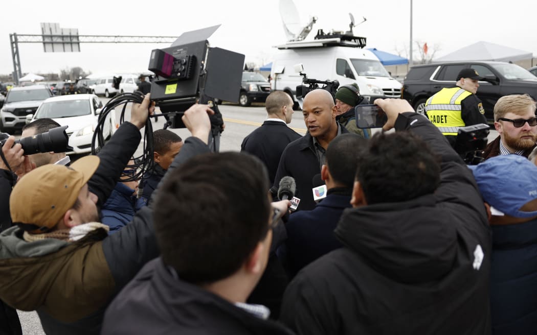 BALTIMORE, MARYLAND - MARCH 27: Maryland Governor Wes Moore speaks to reporters near the collapsed Francis Scott Key Bridge on March 27, 2024 in Baltimore, Maryland. Two survivors were pulled from the Patapsco River and six missing people are presumed dead after the Coast Guard called off rescue efforts. A work crew was fixing potholes on the bridge, which is used by roughly 30,000 people each day, when the ship struck at around 1:30am on Tuesday morning. The accident has temporarily closed the Port of Baltimore, one of the largest and busiest on the East Coast of the U.S.   Anna Moneymaker/Getty Images/AFP (Photo by Anna Moneymaker/Getty Images) (Photo by Anna Moneymaker / GETTY IMAGES NORTH AMERICA / Getty Images via AFP)