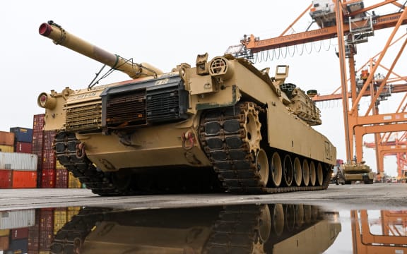 In this file photo taken on 3 December, 2022, an M1A2 Abrams battle tank of the US army, that will be used for military exercises by the 2nd Armored Brigade Combat Team, is unloaded at the Baltic Container Terminal in Gdynia, Poland.
