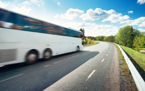 Bus on asphalt road in beautiful spring day at countryside