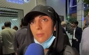 This image grab from footage obtained from Iranian State agency IRNA on October 19, 2022 shows Elnaz Rekabi, an Iranian climber who caused a sensation by competing at an event abroad without a hijab, giving an interview upon her arrival at Imam Khomeini International Airport in Tehran. - Rekabi was given a hero's welcome on her return to Tehran by supporters who raucously applauded her action. With Iran still shaken by women-led protests over the death of Mahsa Amini one month ago, Elnaz Rekabi flew back to a Tehran airport after the competition in South Korea. (Photo by IRNA / AFP) / Israel OUT - NO Resale / RESTRICTED TO EDITORIAL USE - MANDATORY CREDIT "AFP PHOTO / HO /IRNA" - NO MARKETING NO ADVERTISING CAMPAIGNS - DISTRIBUTED AS A SERVICE TO CLIENTS  /NO RESALE/ NO ACCESS ISRAEL MEDIA/PERSIAN LANGUAGE TV STATIONS/ OUTSIDE IRAN/ STRICTLY NO ACCESS BBC PERSIAN/ VOA PERSIAN/...