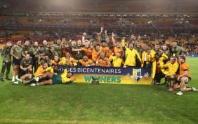 Wallabies players celebrate their win over France in the third rugby test in Brisbane on Saturday 17th July 2021.