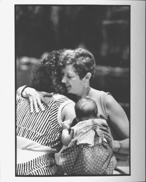 Feminist Norma McCorvey aka Jane Roe, the woman behind Roe V. Wade case, hugging her 23 year old daughter, Cheryl while holding her baby granddaughter outside at hotel.