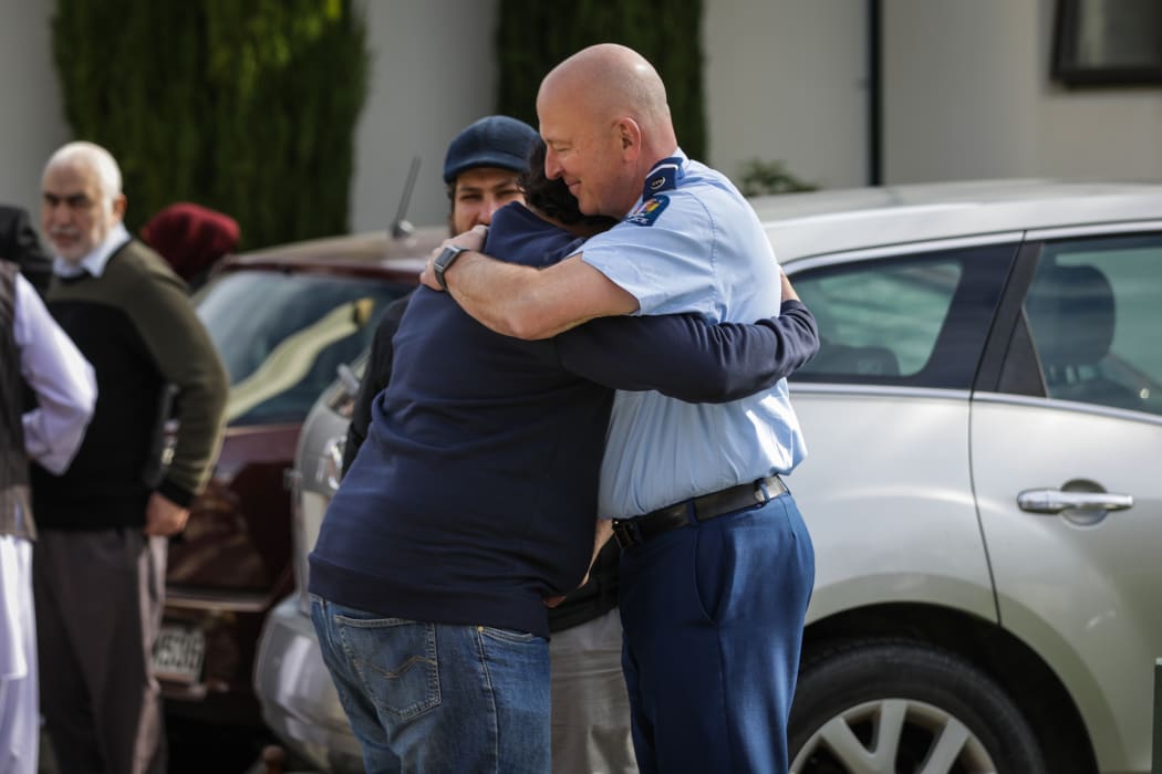 Worshippers greet police at Al Noor mosque in the first Friday prayers since the Christchurch mosque shooter's sentencing.