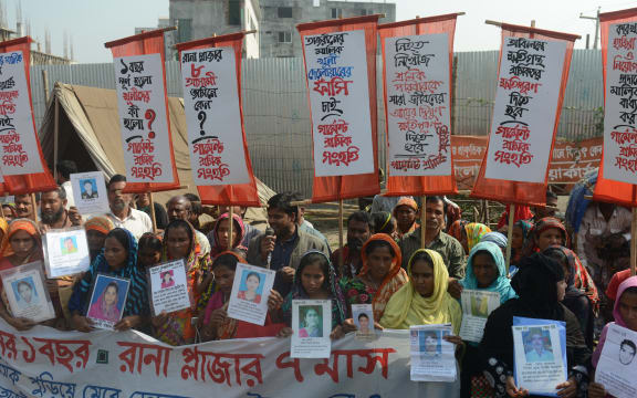 Survivors and relatives of Bangladeshi garment workers killed in the Tazreen Fashions fire accident and Rana Plaza garment factory building collapse react gather for a demonstration in Savar, on the outskirts of Dhaka on November 24, 2013.