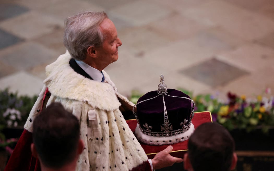 17th Century St Edward's Imperial State Crown is carried at Westminster Abbey in central London on May 6, 2023, ahead of the coronations of Britain's King Charles III and Britain's Camilla, Queen Consort. - The set-piece coronation is the first in Britain in 70 years, and only the second in history to be televised. Charles will be the 40th reigning monarch to be crowned at the central London church since King William I in 1066. Outside the UK, he is also king of 14 other Commonwealth countries, including Australia, Canada and New Zealand. Camilla, his second wife, will be crowned queen alongside him, and be known as Queen Camilla after the ceremony. (Photo by PHIL NOBLE / POOL / AFP)