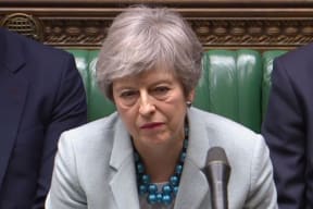 Britain's Prime Minister Theresa May listen as opposition leader Jeremy Corbyn speaks in the House of Commons in London on March 25, 2019 after May outlined the next steps that parliament will take in the Brexit process.