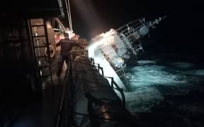 A picture shared by Thailand's navy on 19 December, 2022 shows the HTMS Sukhothai warship flipped over onto its side.