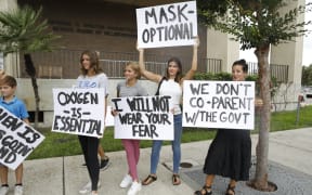 Families protest before a Hillsborough County Schools Board meeting about masks in Tampa, Florida.