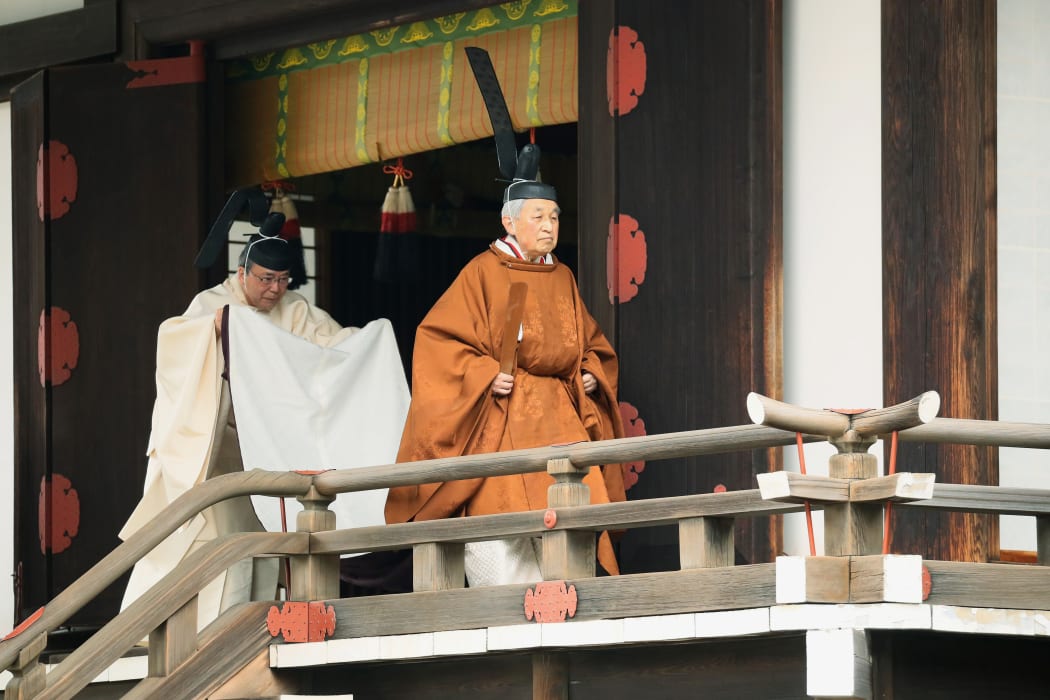 Japan's Emperor Akihito, right, leaves after a ritual to report his abdication to the throne, at the Imperial Palace in Tokyo on 30 April, 2019.
