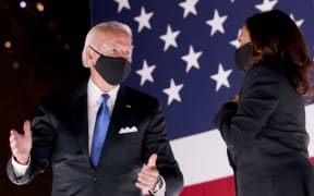 Democratic presidential nominee Joe Biden and Democratic Vice Presidential nominee Kamala Harris confer on stage outside the Chase Center after Biden delivered his acceptance speech  in Wilmington, Delaware.