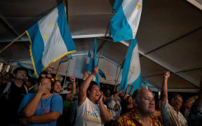 Pro-independence Tavini party supporters cheer after their victory following the second round of the territorial elections, at party headquarters in Faa'a.