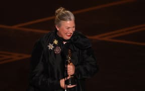 US costume designer Kate Hawley holds her Oscar for Best Costume Design for "Frankenstein" onstage during the 98th Annual Academy Awards at the Dolby Theatre in Hollywood, California on March 15, 2026.