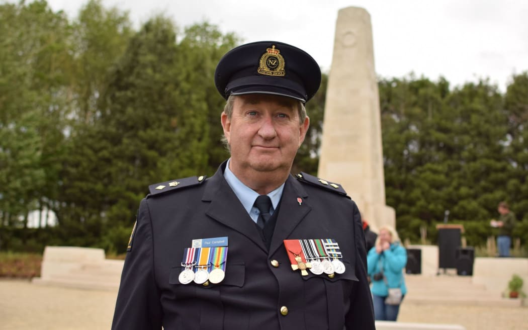 New Zealand Customs attache to Belgium Paul Campbell with his grandfather's war medals at the New Zealand Messines Ridge Memorial.
