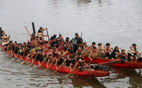 The waka flotilla passes along the estuary at Waitangi as it’s welcomed to the beach by Te Tii marae.