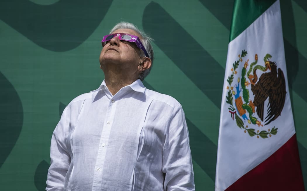 Mexican President Andres Manuel Lopez Obrador wears special sunglasses as he observes a solar eclipse moments before totality, in Mazatlan, Sinaloa State, Mexico, on April 8, 2024.