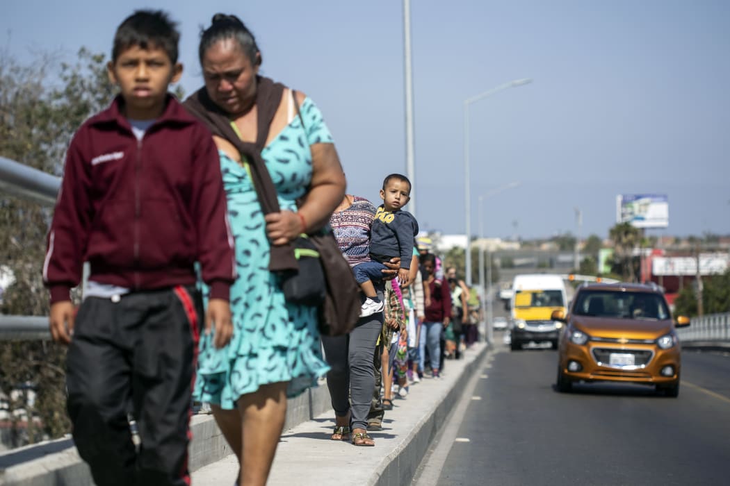Central American migrants travelling in the "Migrant Via Crucis" caravan walk to their legal counselling meeting in Tijuana, Baja California state, Mexico, on April 28, 2018.