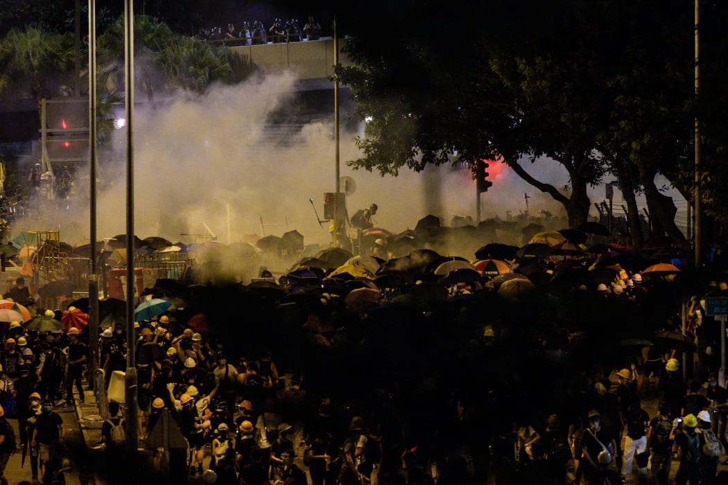Police fire tear gas at protesters near the government headquarters in Hong Kong.