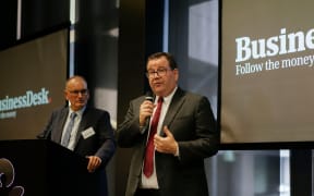 Pattrick Smellie (left) watches finance minister Grant Robertson at the Acukland launch of BusinessDesk subscriber service on Wednesday.