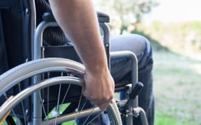 Paralyzed man using his wheelchair