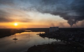 Smoke rises from the cities of Bucha, Irpin and Hostomel near Kyiv, on 25 March.