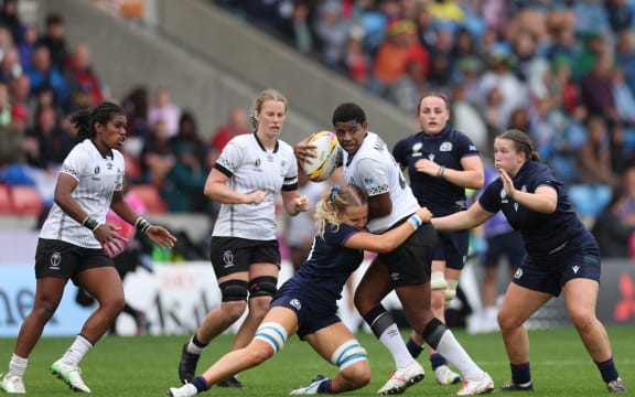 Fiji's Adi Salote Nailolo (C) is tackled during the Women’s Rugby World Cup pool B match between Scotland and Fiji at Salford Community Stadium, Manchester, northwest England, on August 30, 2025. (Photo by Adrian Dennis / AFP)