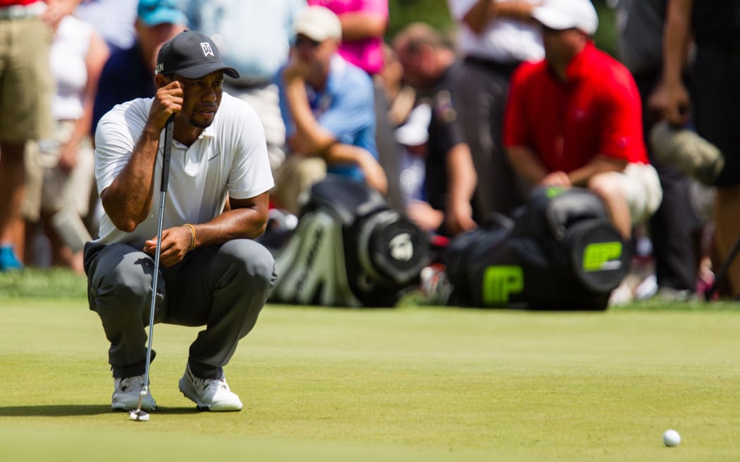 Tiger Woods lines up his putt on 9 during the second round of the Quicken Loans National at Congressional Country Club in Bethesda, MD. 2014.