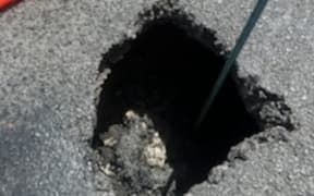 A stretch of highway south of New Plymouth is closed to southbound traffic until later tonight after a tomo, or sinkhole opened up.