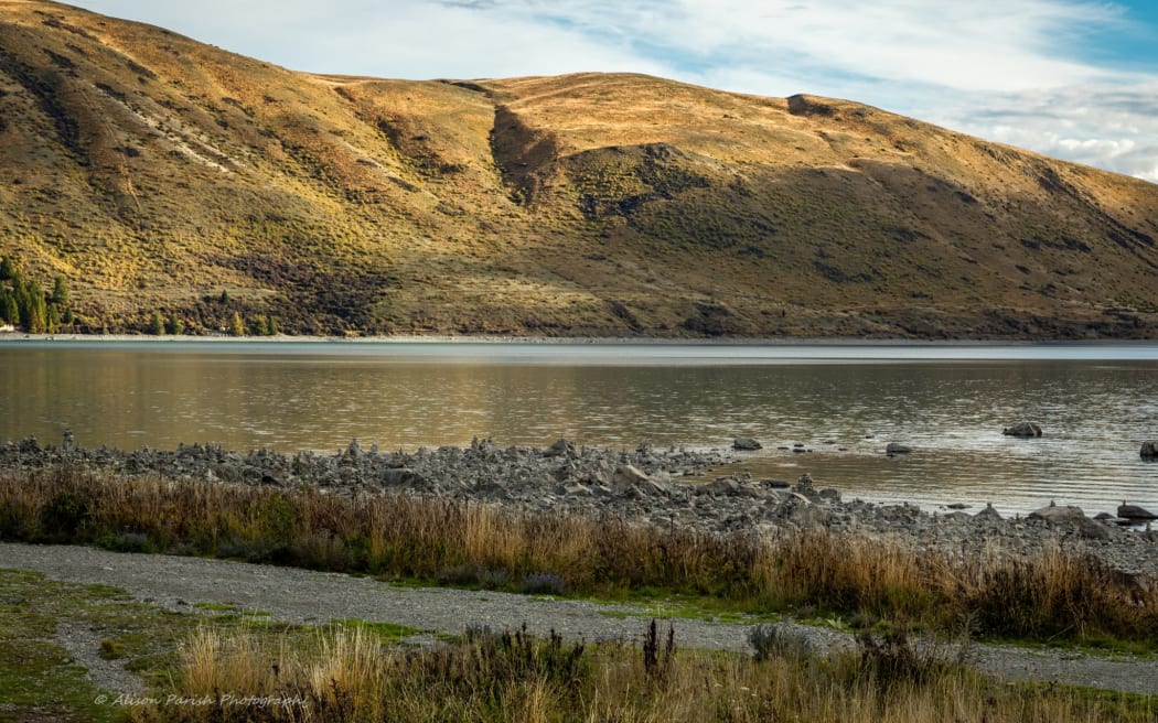 Stone cairns on the shore of Lake Tekapo.
