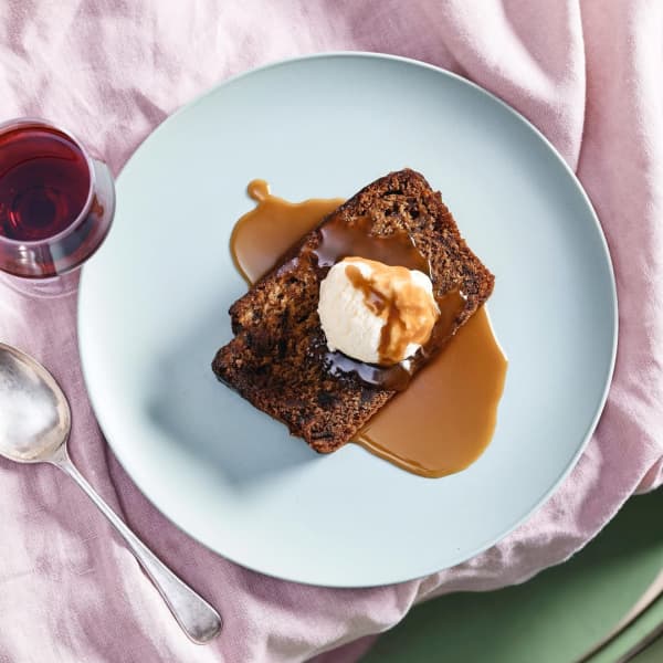 A brown piece of pudding on a blue plate.
