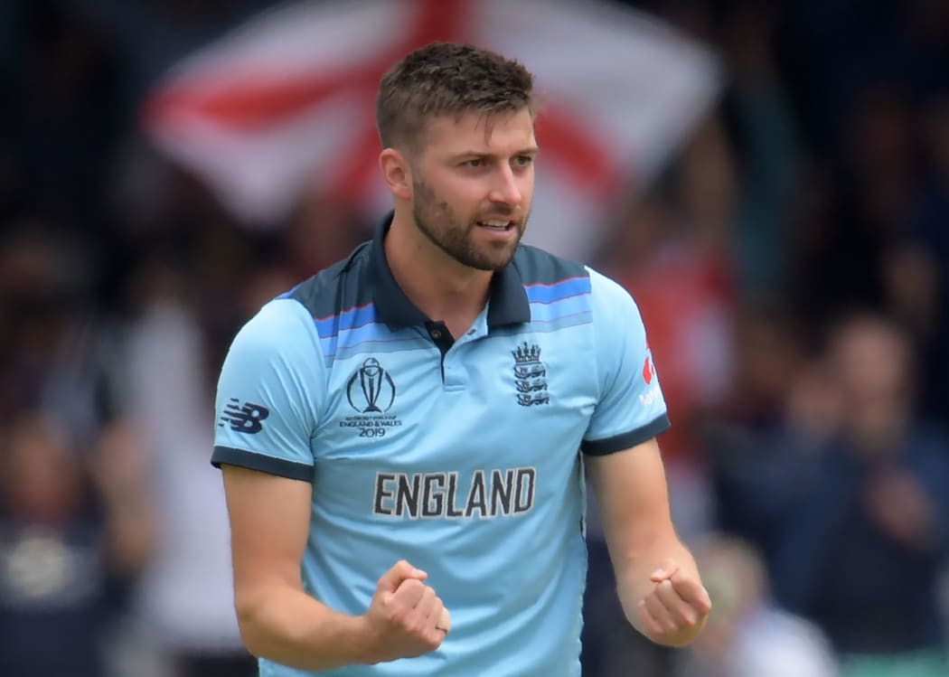 England's Mark Wood celebrates after the dismissal of New Zealand's Ross Taylorduring the 2019 Cricket World Cup final between England and New Zealand at Lord's Cricket Ground in London on July 14, 2019. (Photo by Dibyangshu Sarkar / AFP) / RESTRICTED TO EDITORIAL USE