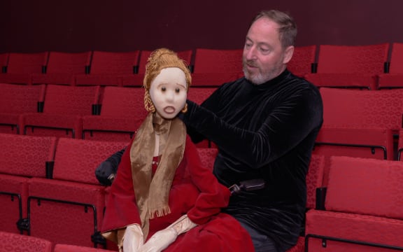 Puppeteer Kenny King sits next to the puppet 'Lady'.