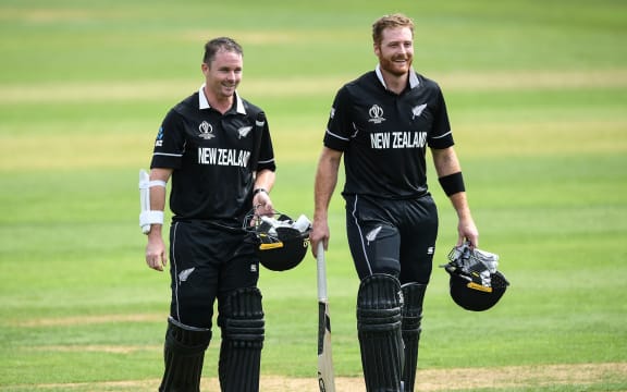 Colin Munro and Martin Guptill walk from the field.